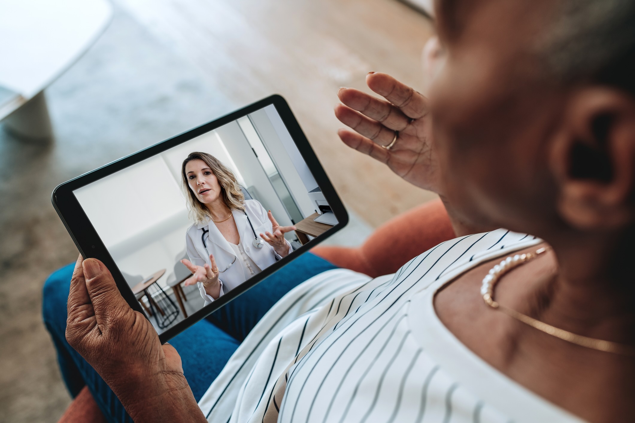 Patient on a video visit with a doctor on a tablet